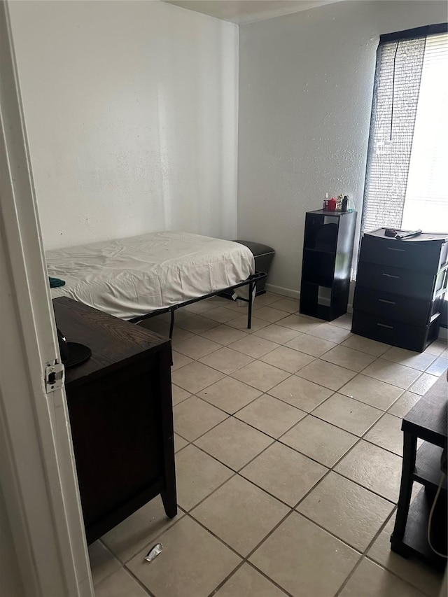 bedroom with light tile patterned flooring