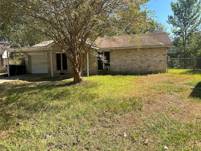 ranch-style home featuring a garage and a front lawn