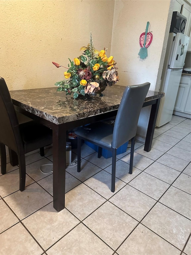 dining space featuring light tile patterned floors