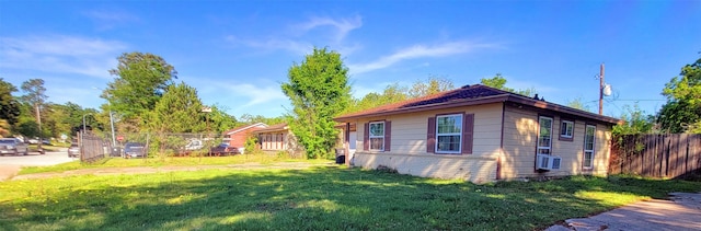 view of side of home with a yard and cooling unit