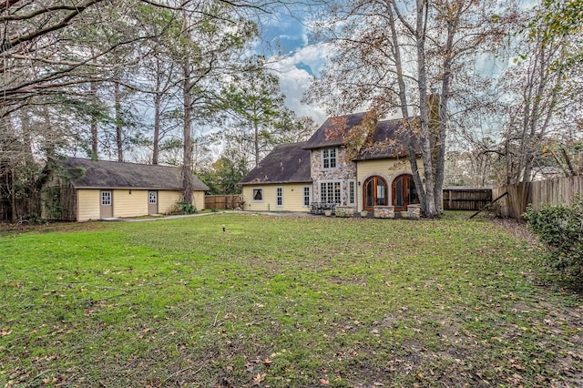 rear view of property with a yard