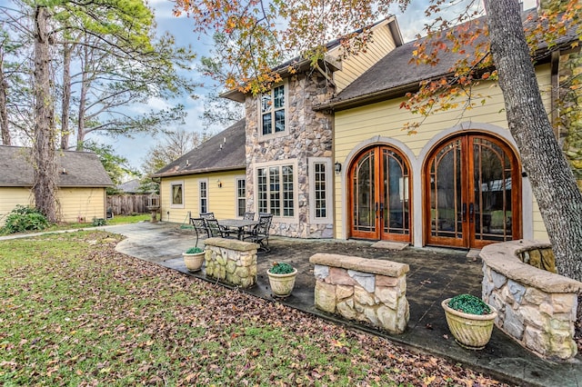 rear view of house with french doors and a patio area