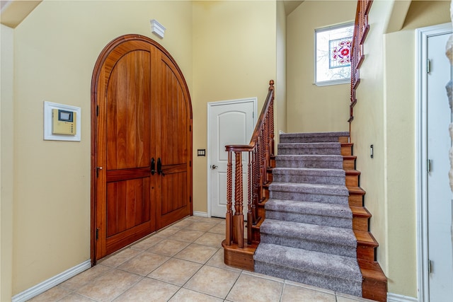 foyer entrance with light tile patterned floors