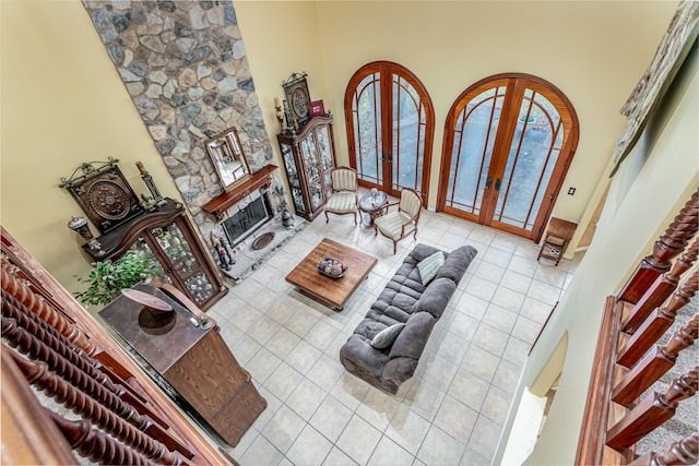 living room featuring tile patterned flooring, french doors, and a wealth of natural light