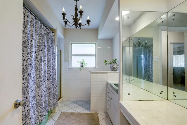 bathroom featuring walk in shower, tile patterned flooring, a notable chandelier, vanity, and tile walls