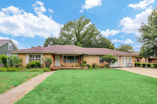 ranch-style home with a front yard and french doors