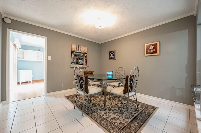 dining area with crown molding, light tile patterned floors, and a textured ceiling