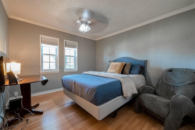 bedroom with crown molding, light wood-type flooring, and ceiling fan