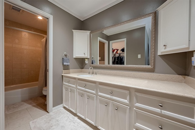 full bathroom featuring tile patterned floors, tiled shower / bath, toilet, vanity, and ornamental molding