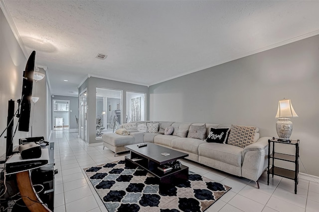 living room featuring a textured ceiling, light tile patterned floors, and ornamental molding