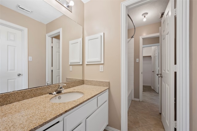 bathroom with shower / bathing tub combination, vanity, a textured ceiling, and tile patterned floors