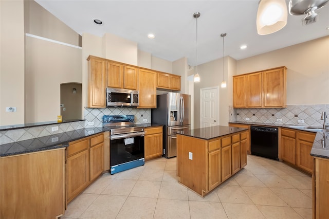 kitchen with hanging light fixtures, light tile patterned floors, stainless steel appliances, and tasteful backsplash