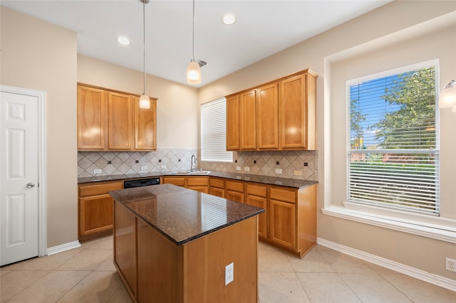 kitchen with pendant lighting, light tile patterned floors, and tasteful backsplash