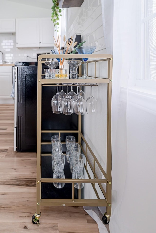 interior details featuring wet bar and hardwood / wood-style flooring