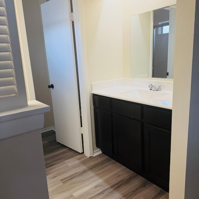 bathroom featuring hardwood / wood-style floors and vanity