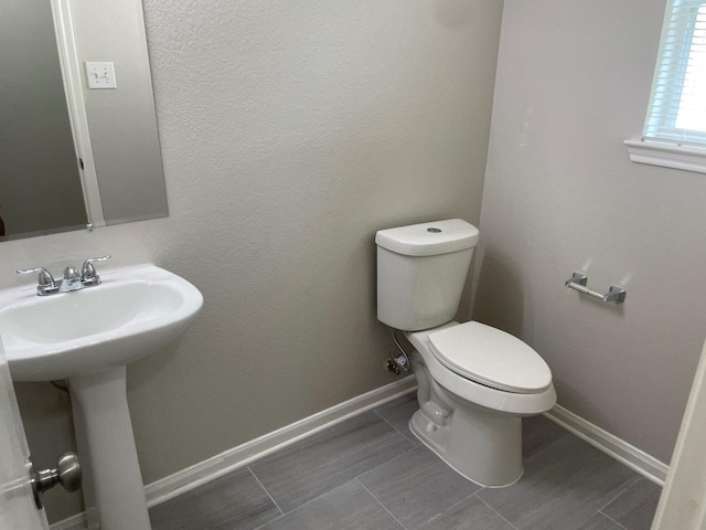 bathroom featuring tile patterned floors, toilet, and sink