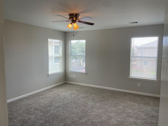 spare room with ceiling fan and carpet floors