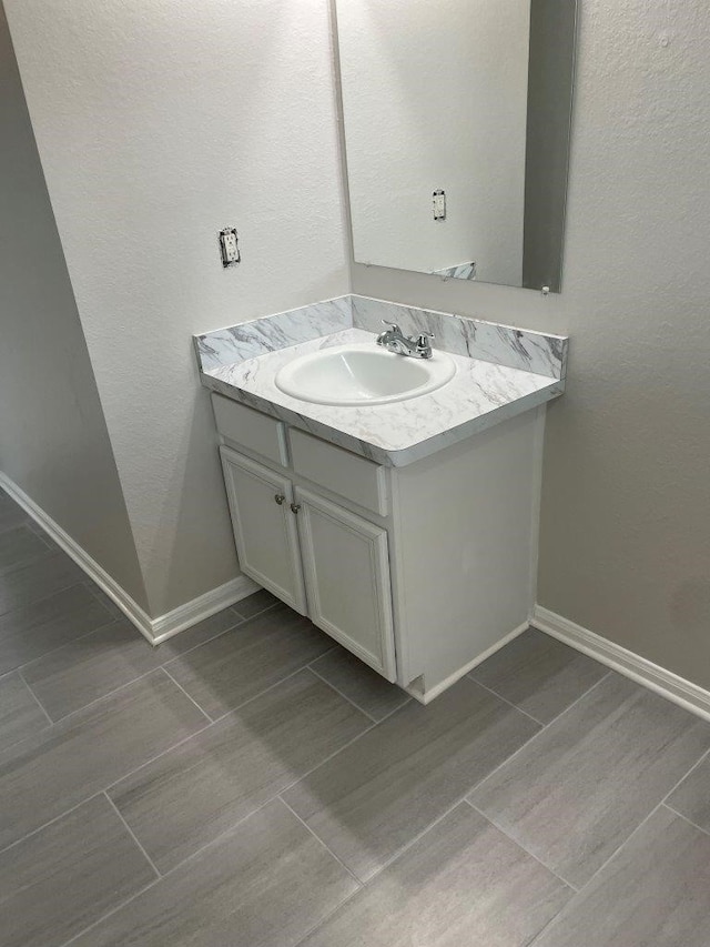 bathroom with tile patterned flooring and vanity