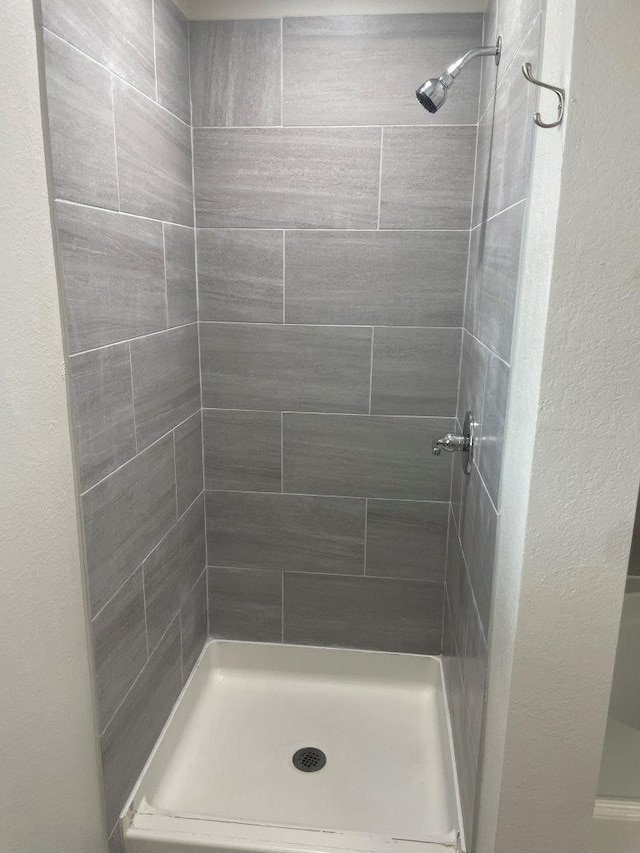 bathroom with tiled shower