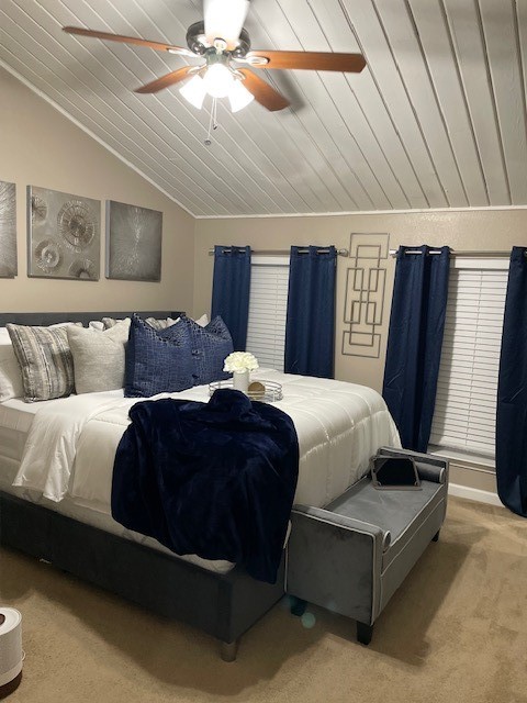 bedroom featuring wooden ceiling, ceiling fan, vaulted ceiling, and carpet flooring