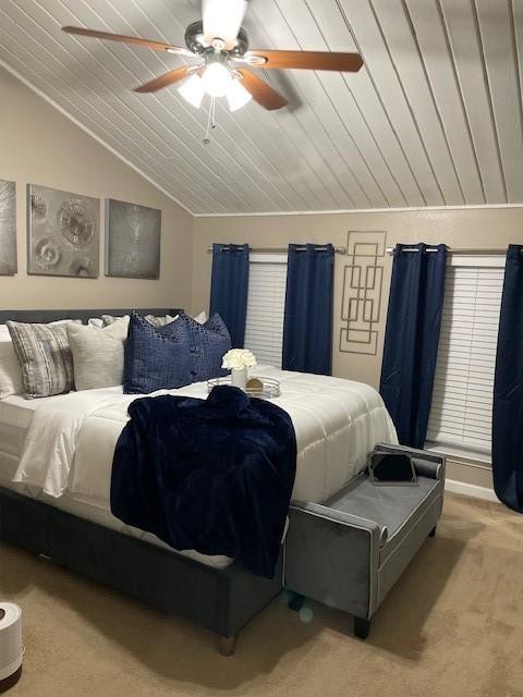 bedroom with lofted ceiling, ceiling fan, light carpet, and wood ceiling