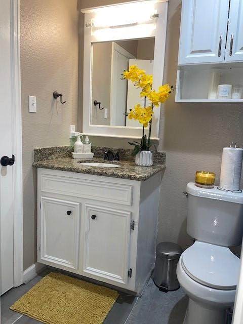 bathroom featuring toilet and vanity