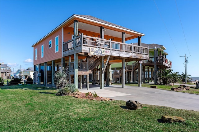 back of property featuring a carport, a porch, and a lawn