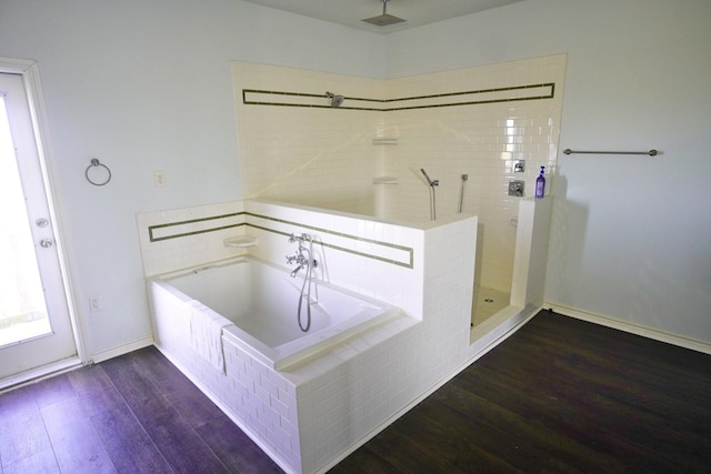 bathroom featuring hardwood / wood-style flooring and separate shower and tub