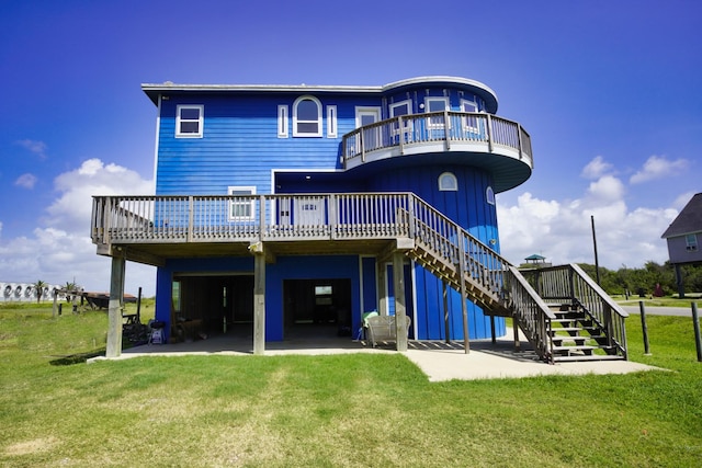 rear view of house featuring a lawn, a patio area, and a deck