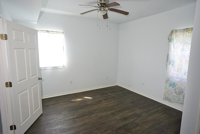 empty room with dark hardwood / wood-style floors and ceiling fan