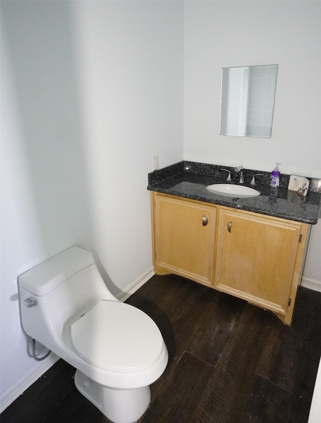 bathroom featuring hardwood / wood-style floors, vanity, and toilet