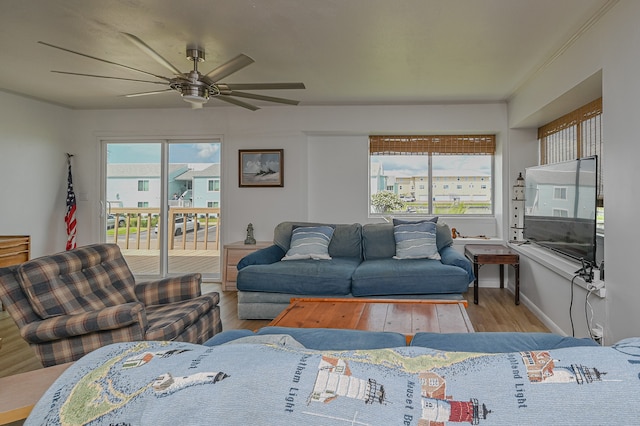 living room featuring wood-type flooring and ceiling fan