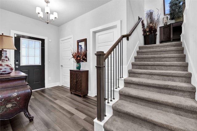 foyer featuring a chandelier and dark hardwood / wood-style flooring