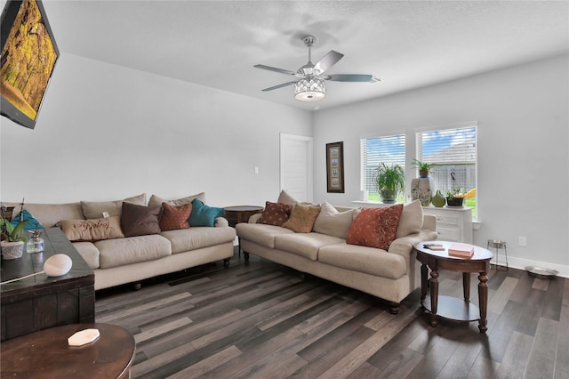 living room featuring dark hardwood / wood-style flooring and ceiling fan