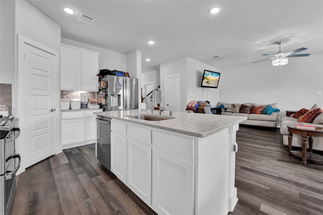 kitchen with white cabinetry, an island with sink, sink, and stainless steel appliances