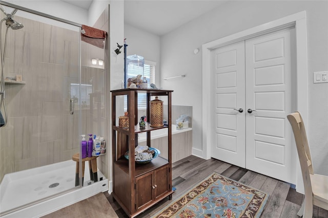 bathroom featuring hardwood / wood-style floors and a shower with door