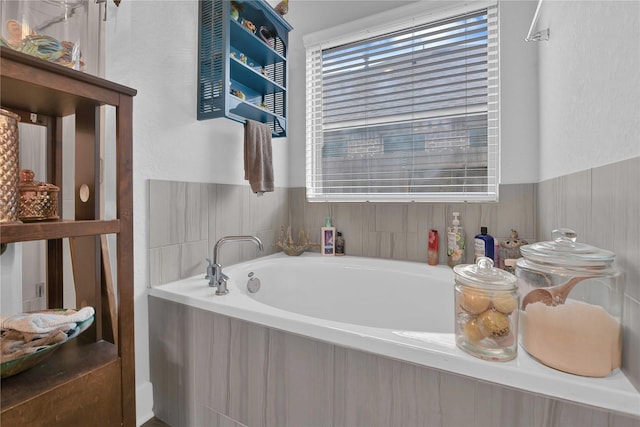 bathroom featuring tiled tub