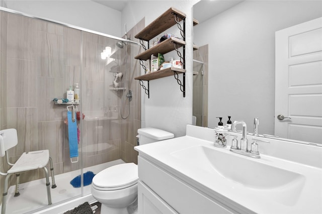 bathroom with vanity, toilet, and walk in shower