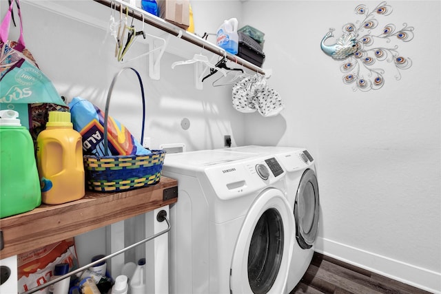 clothes washing area with dark wood-type flooring and washing machine and clothes dryer