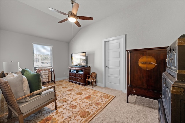 sitting room with vaulted ceiling, light carpet, and ceiling fan