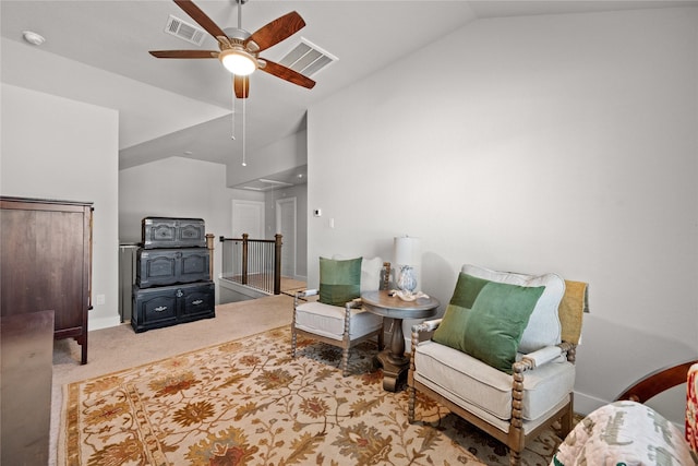 living area with vaulted ceiling, light carpet, and ceiling fan