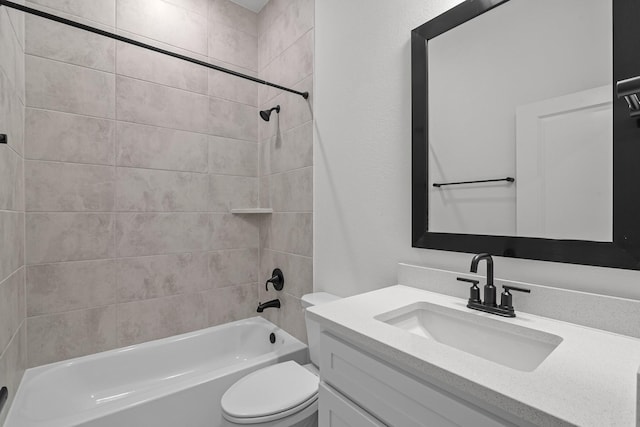 full bathroom featuring toilet, vanity, and tiled shower / bath