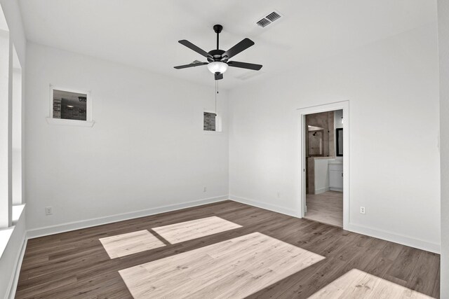 spare room with dark hardwood / wood-style floors and ceiling fan