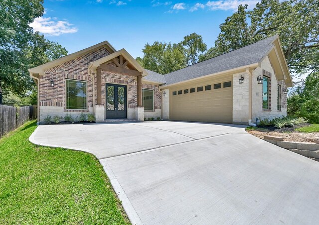 view of front of house with a garage and a front lawn