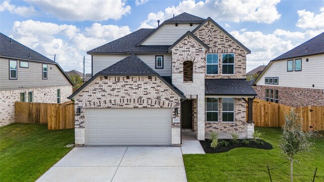 view of front of home with a front yard and a garage