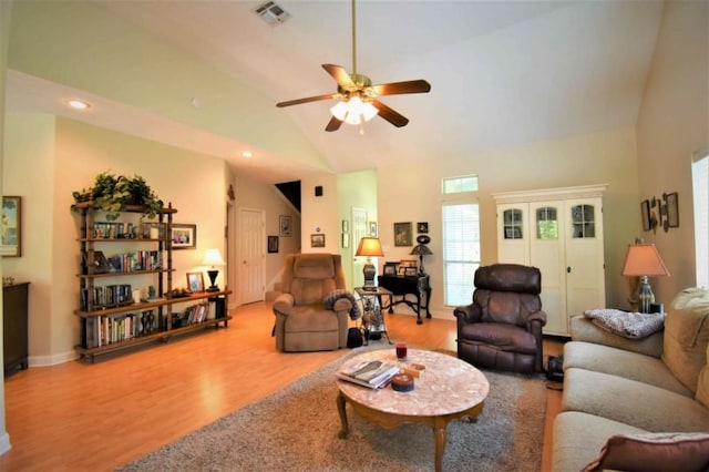 living room with hardwood / wood-style flooring, high vaulted ceiling, and ceiling fan