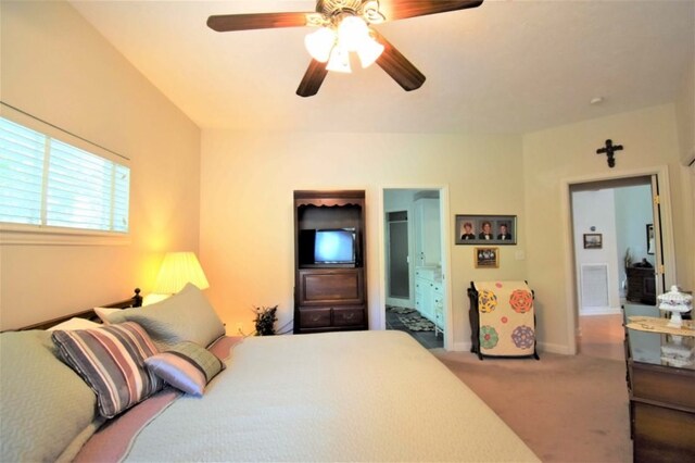 carpeted bedroom featuring ceiling fan and ensuite bath