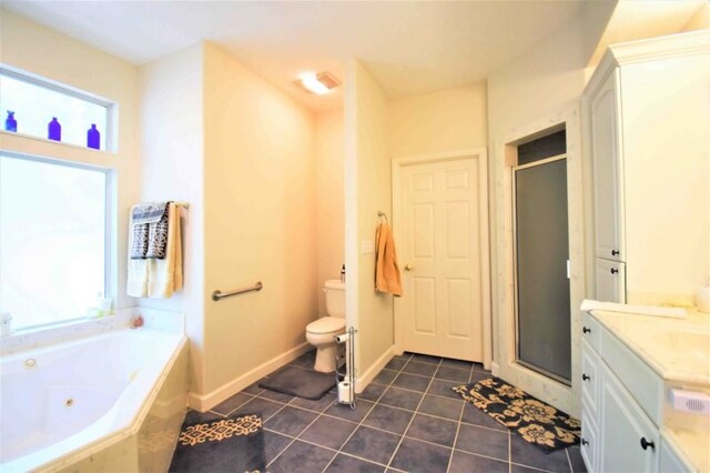 full bathroom featuring a wealth of natural light, toilet, vanity, and tile patterned floors