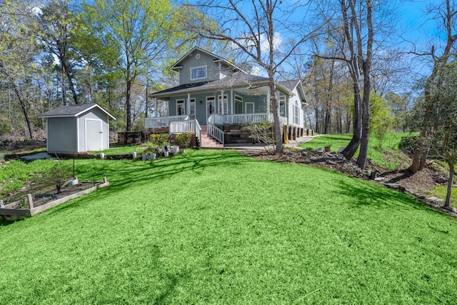 view of front of house featuring an outbuilding, a front yard, a vegetable garden, a porch, and a storage shed