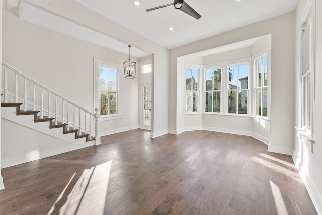 entrance foyer featuring dark wood-type flooring, baseboards, and stairs